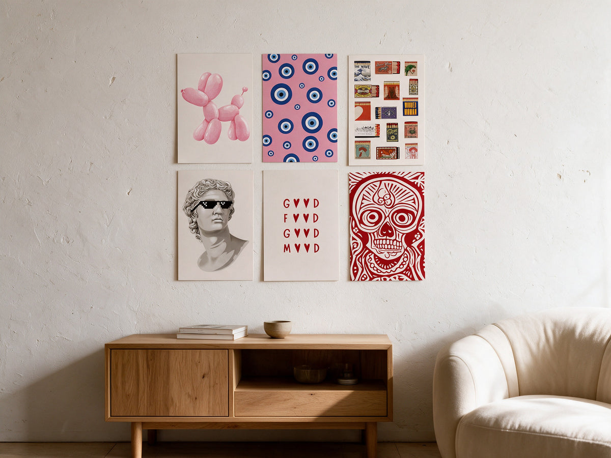 Six A4 matte art posters arranged directly on a wall above a console and sofa