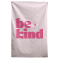 Pink Be Kind lettering and two small sparkle shapes sit on a pale pink field in this simple Wall Rebel fabric wall flag.