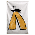 A black-and-white dancer raises one arm above oversized mustard-yellow trousers on a pale background on a Wall Rebel fabric wall flag.