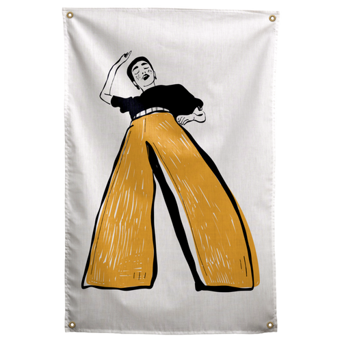 A black-and-white dancer raises one arm above oversized mustard-yellow trousers on a pale background on a Wall Rebel fabric wall flag.