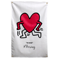 A red heart with black outlined arms and legs dances above small THE HEART lettering on pale cream on a Wall Rebel fabric wall flag.