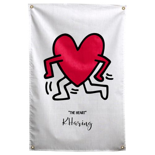A red heart with black outlined arms and legs dances above small THE HEART lettering on pale cream on a Wall Rebel fabric wall flag.