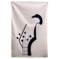 A dark stylised bass headstock rises above visible strings and tuning pegs on a pale peach ground on a Wall Rebel fabric wall flag.