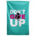 A black-clad skier jumps across pink and white Don't Give Up words on turquoise in this energetic Wall Rebel fabric wall flag.