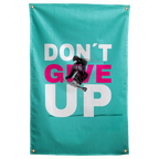 A black-clad skier jumps across pink and white Don't Give Up words on turquoise in this energetic Wall Rebel fabric wall flag.