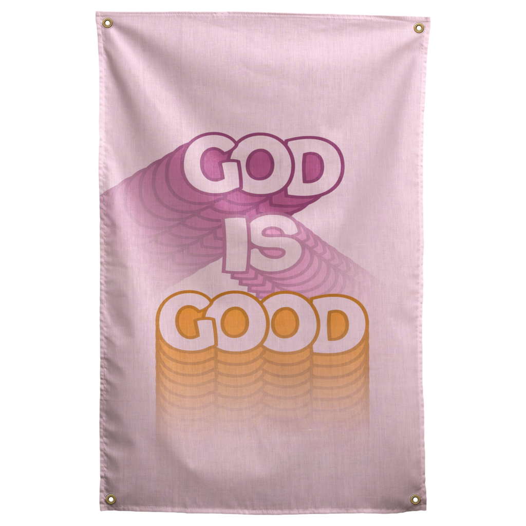 God Is Good lettering trails pastel purple and yellow dimensional shadows across pale pink on this Wall Rebel fabric wall flag.