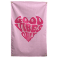 Rounded dark pink Good Vibes Only lettering forms a heart on pale pink in this playful Wall Rebel fabric wall flag.