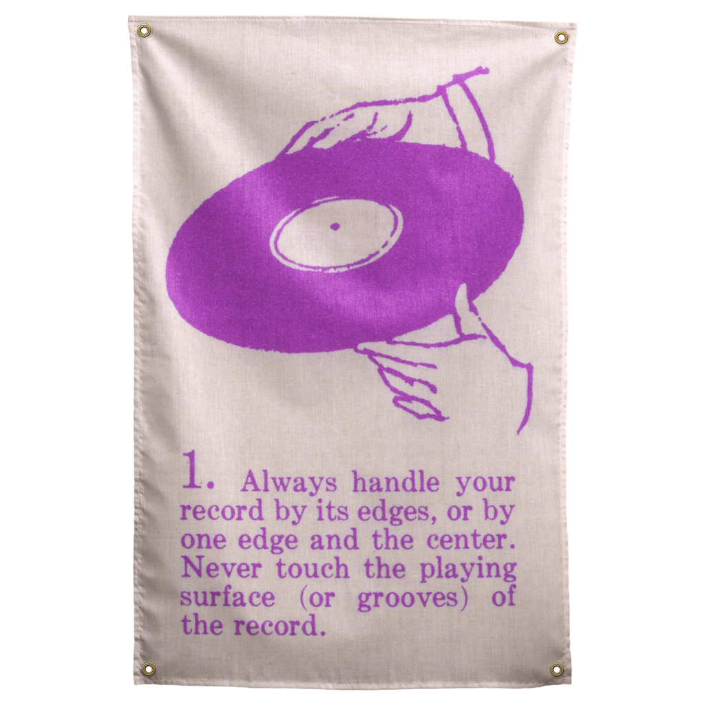 Purple line-drawn hands hold a vinyl record above numbered handling instructions on this cream Wall Rebel fabric wall flag.