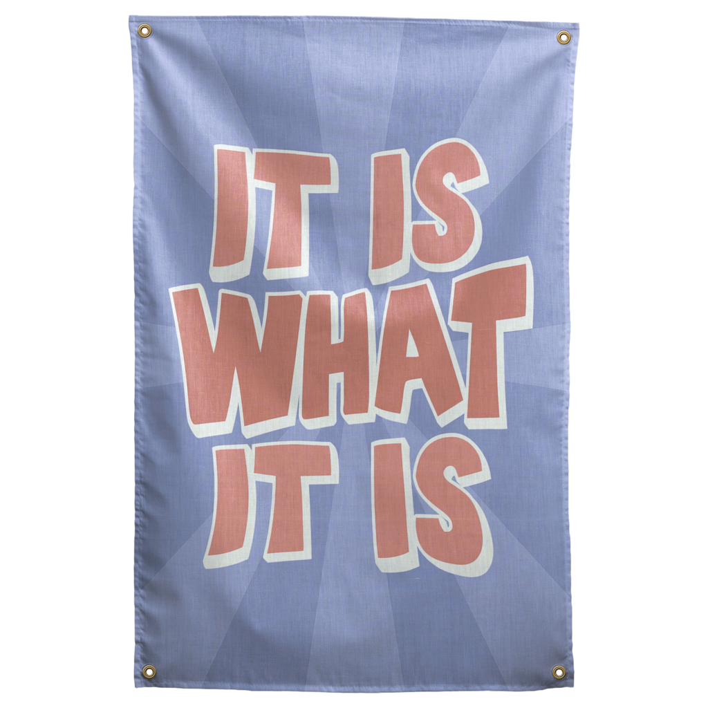 Peach It Is What It Is lettering with pale outlines sits over a blue sunburst on this laid-back Wall Rebel fabric wall flag.