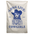 A blue cowgirl portrait with a hat and jewellery sits beneath Long Live Cowgirls words on this Wall Rebel fabric wall flag.