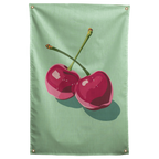 Two glossy pink cherries with angular highlights cast a long shadow across mint green on this Wall Rebel fabric wall flag.