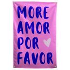 Deep purple MORE AMOR POR FAVOR lettering and a white heart stand out against bright pink on a Wall Rebel fabric wall flag.