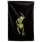 A lime-green skeleton raises a drumstick over a waist-mounted drum against near-black on this Wall Rebel fabric wall flag.