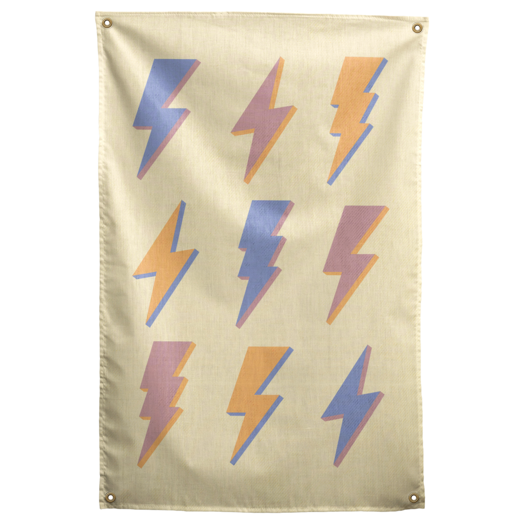 Nine pastel lightning bolts in blue, peach and pink repeat across pale yellow on this patterned Wall Rebel fabric wall flag.