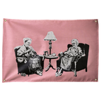 Two seated figures knit slogan blankets against pink in this humorous horizontal Punks Not Dead Wall Rebel fabric wall flag.