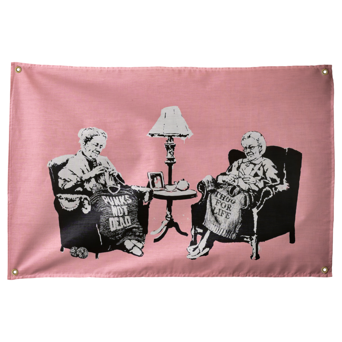 Two seated figures knit slogan blankets against pink in this humorous horizontal Punks Not Dead Wall Rebel fabric wall flag.