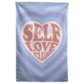 Self Love Club lettering fills a pale heart within layers of blue heart shapes on this patterned Wall Rebel fabric wall flag.