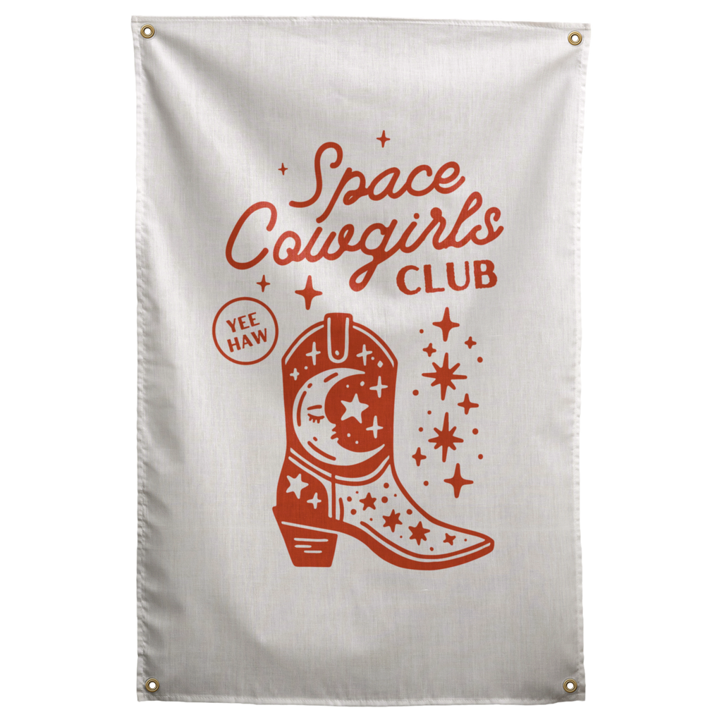 Rust-red Space Cowgirls Club lettering surrounds a cowboy boot with moon and star details on this Wall Rebel fabric wall flag.