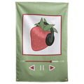 A strawberry in dark headphones appears inside a green music-player-style frame on this playful Wall Rebel fabric wall flag.