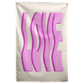 Oversized wavy pink LOVE letters cast darker shadows against cream on this bold typographic Wall Rebel fabric wall flag.