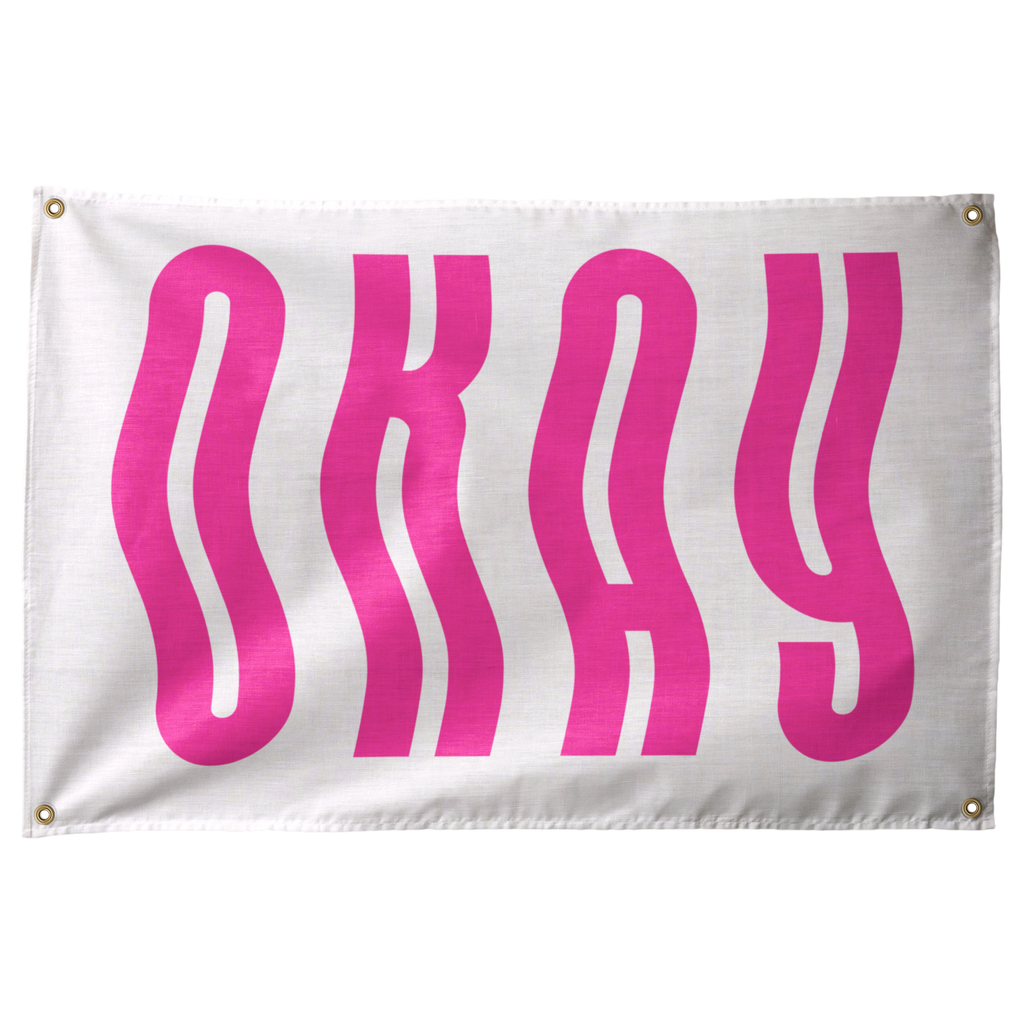 Tall bright pink OKAY letters ripple in vertical waves across a pale horizontal background on a Wall Rebel fabric wall flag.