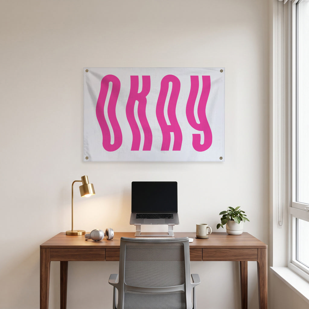 Wavy Pink Okay Wall Flag in the clean desk room mockup.