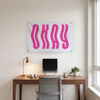 Wavy Pink Okay Wall Flag in the clean desk room mockup.