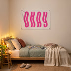 Wavy Pink Okay Wall Flag in the platform bed room mockup.