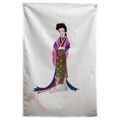 A standing woman wears long pink, blue and patterned Japanese robes against a pale ground with a red seal on a Wall Rebel fabric wall flag.