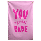 Bright pink You Got This Babe lettering with small accent strokes fills a pale pink Wall Rebel fabric wall flag.