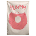 A pink-iced doughnut with sprinkles and a large bite sits below YUMMY lettering on this cream Wall Rebel fabric wall flag.